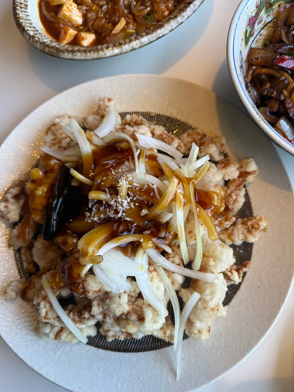 A piece of tangsuyuk topped with black vinegar sauce