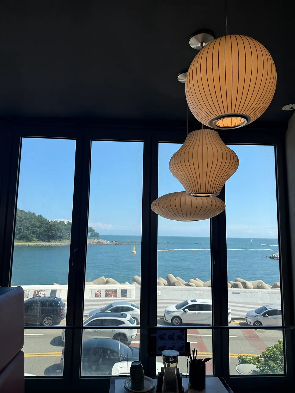 Chinese dishes on the table with the ocean in the background