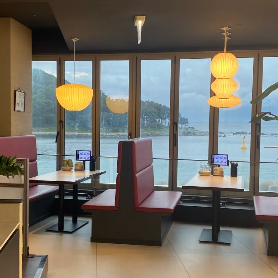 The interior with the sea visible through large windows