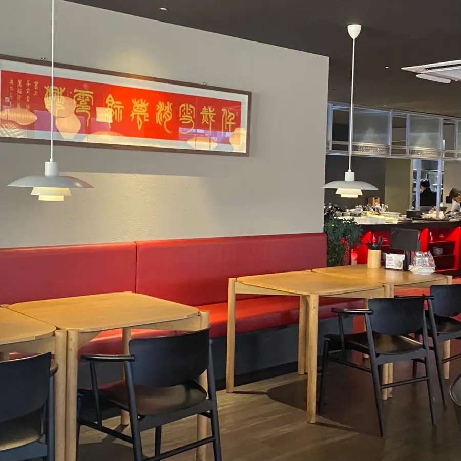 The dining hall decorated with red seats and lighting