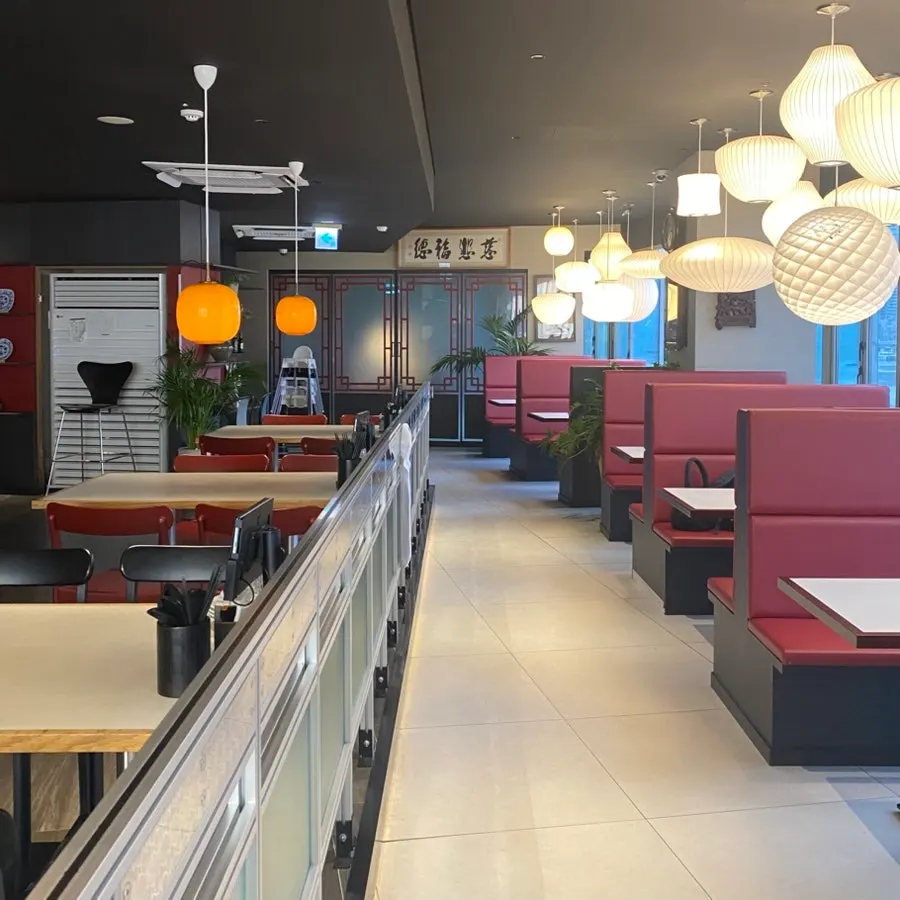 A modern restaurant interior with generously spaced tables