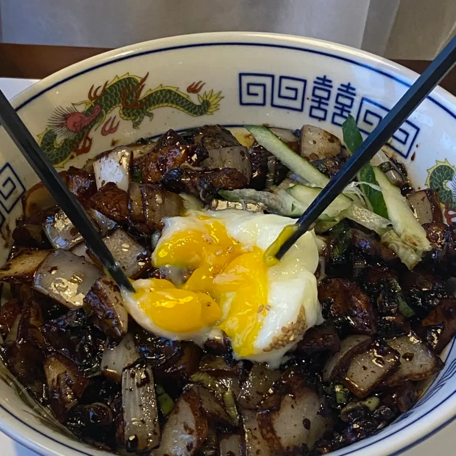 The poached egg sitting on top of the ganjajang