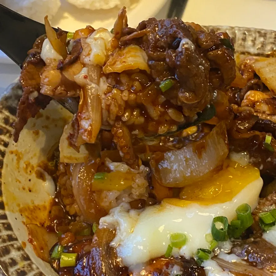 Close-up of the rice bowl showing bite-sized pieces of octopus