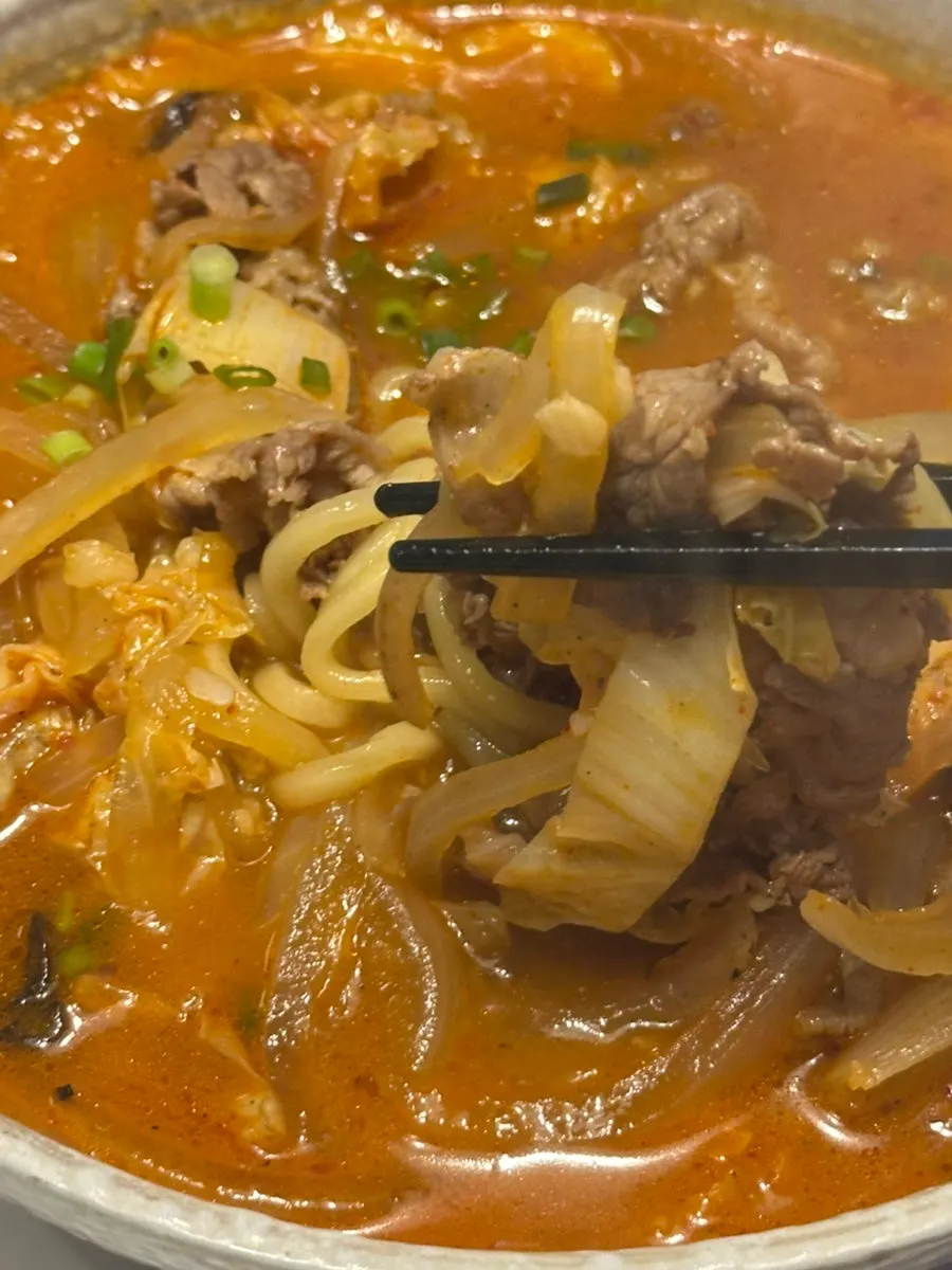 铺满牛肋条的炒码面汤汁特写