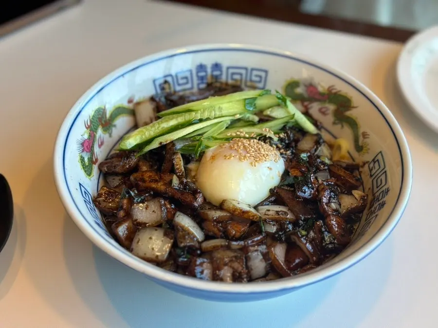 Table setting with ganjajang topped with a poached egg