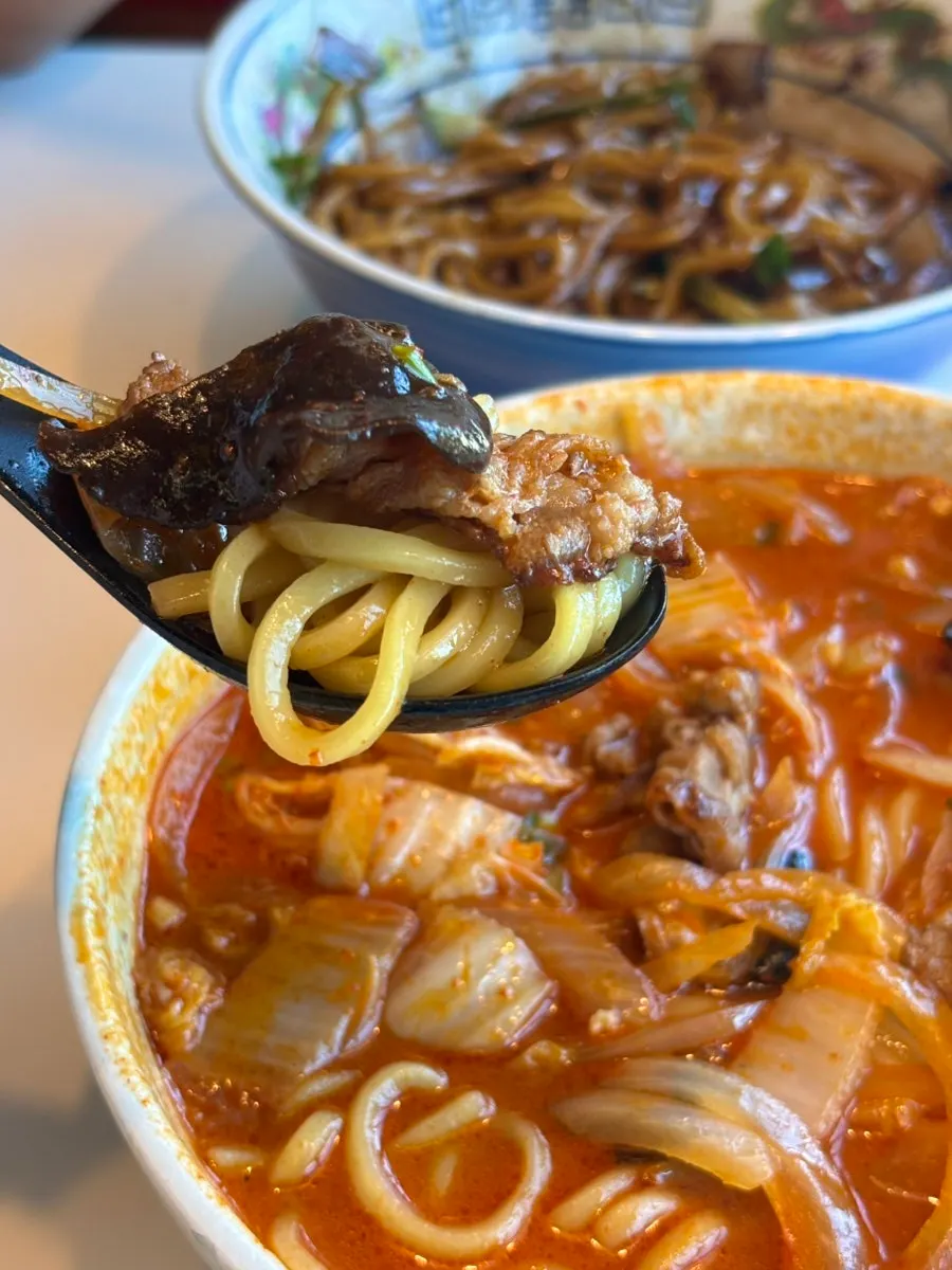 A spoonful of jjamppong loaded with toppings