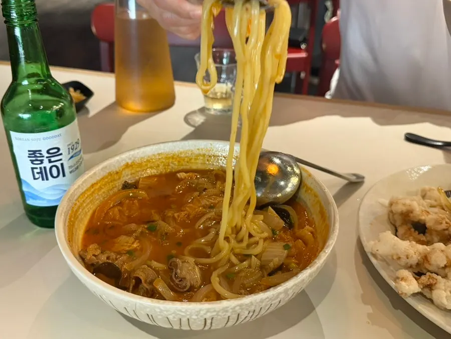 Jjamppong noodles lifted with chopsticks