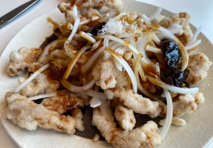 A plate of pork loin tangsuyuk with black vinegar sauce