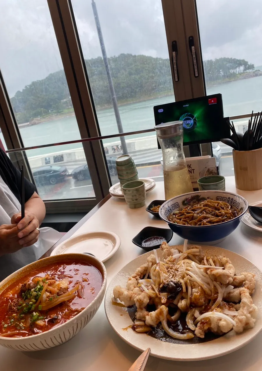 Table set with tangsuyuk, ganjajang, and jjamppong side by side