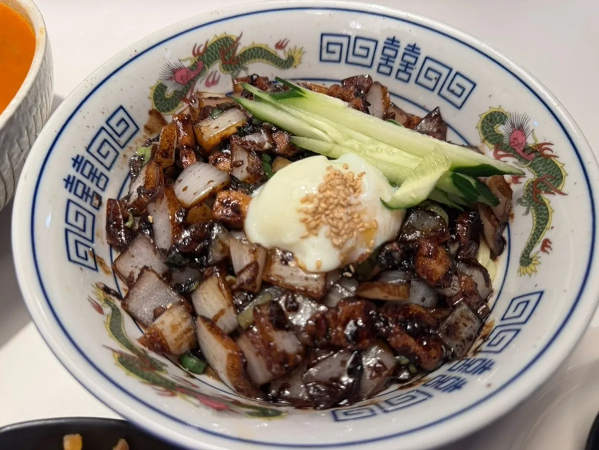 Table spread with poached-egg jjajangmyeon, seafood jjamppong, and jalapeño cream shrimp