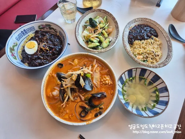 A full Chinese meal spread by the ocean-view window