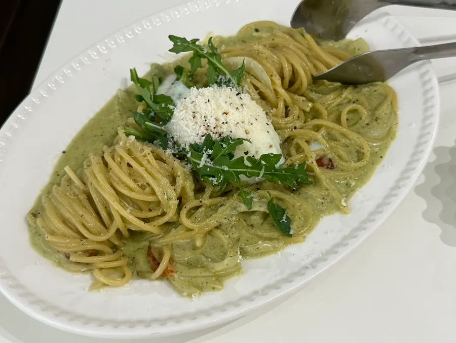 Basil pesto cream sauce pasta mixed with the yolk