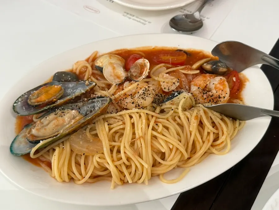 Seafood tomato pasta topped with seafood
