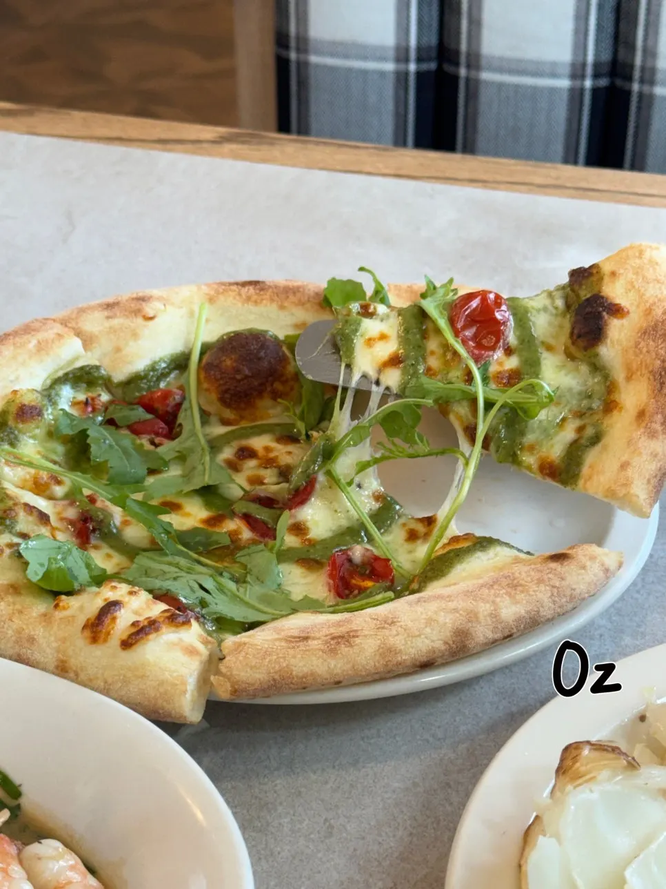 A slice of margherita pizza topped with cheese and basil