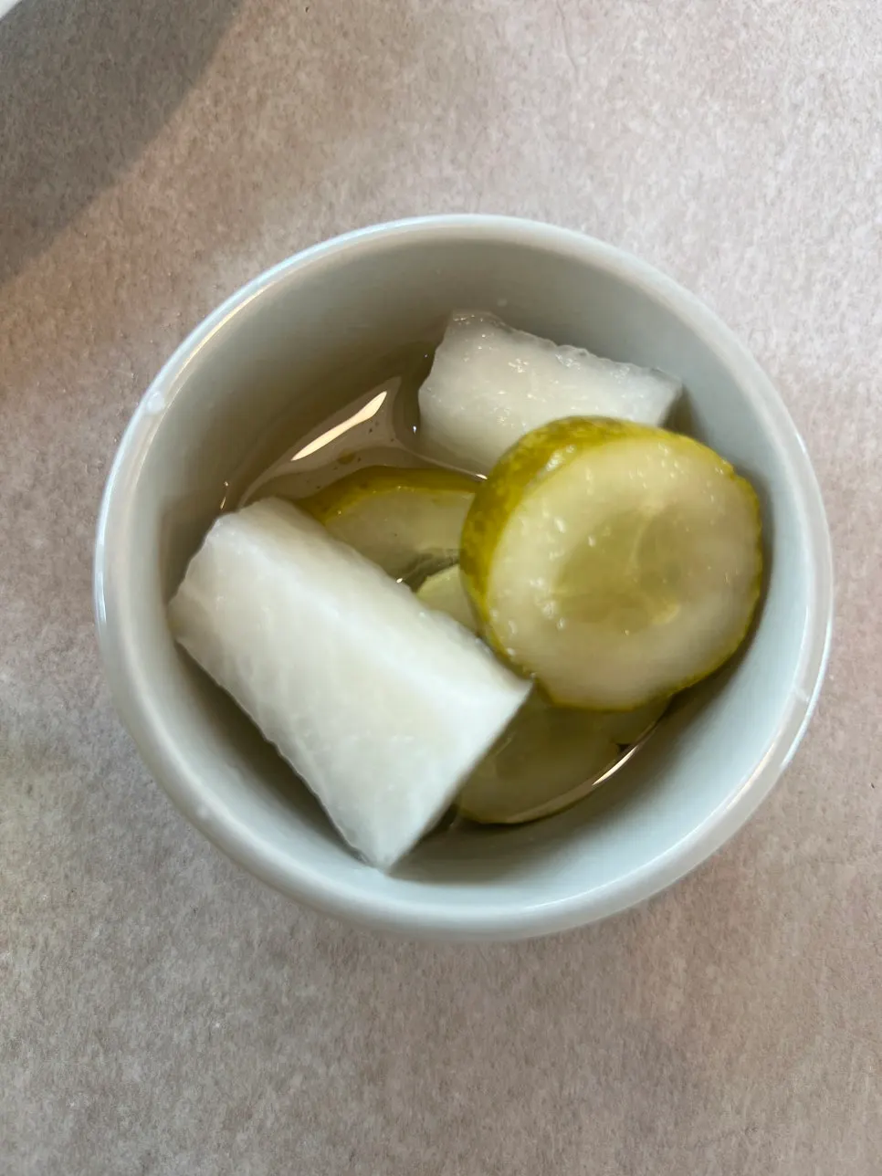 Pickles and Tabasco sauce served with the pizza