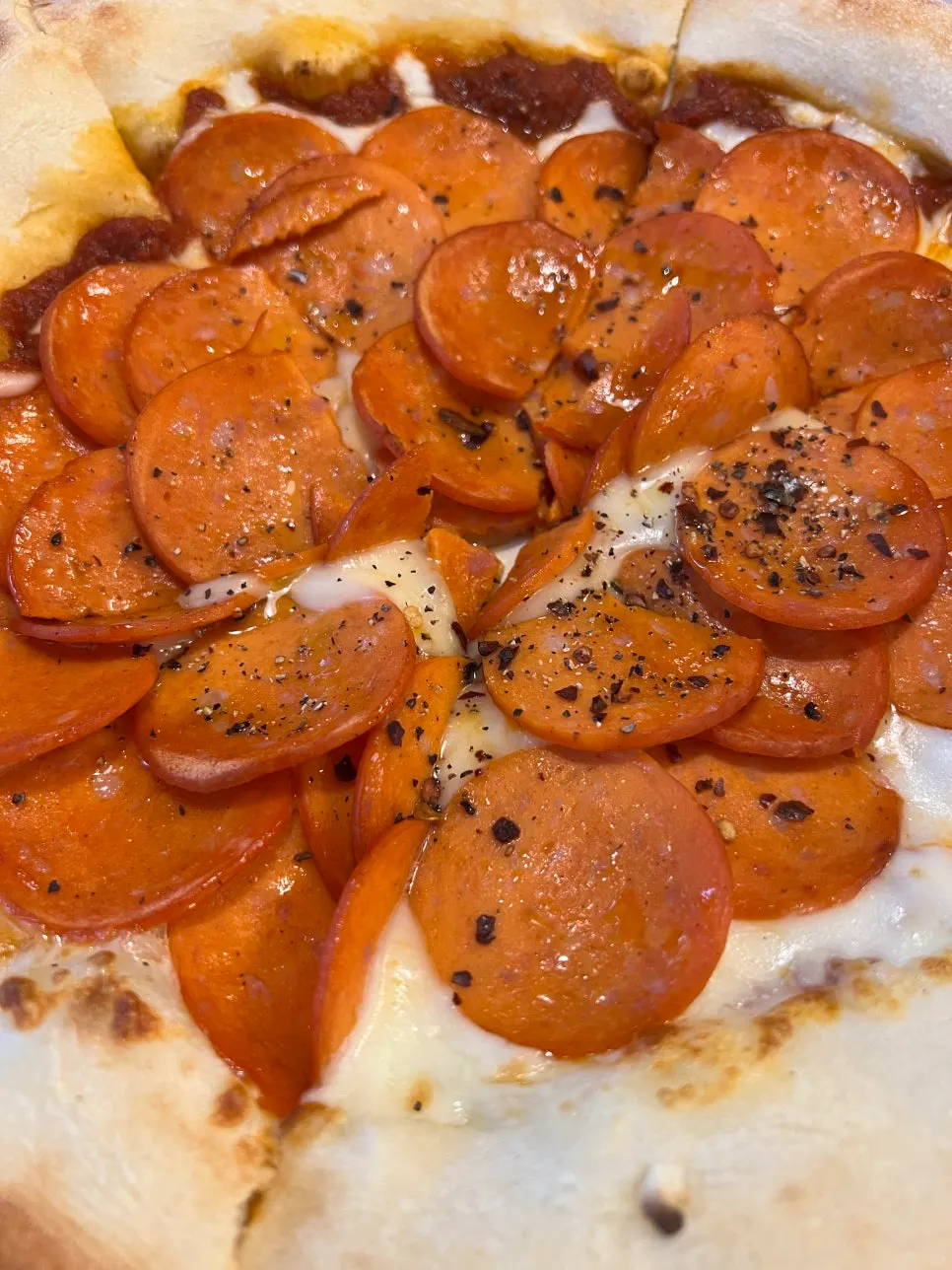 A slice of pepperoni pizza piled high with toppings