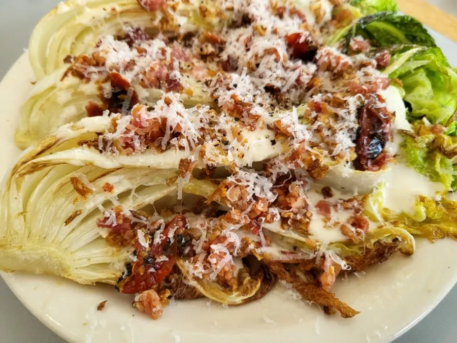 A plate of napa cabbage Caesar salad