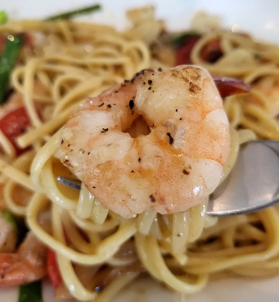 Oil pasta noodles lifted with a fork