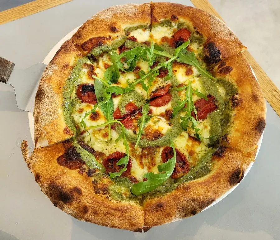Salad, pasta, and pizza set on the table