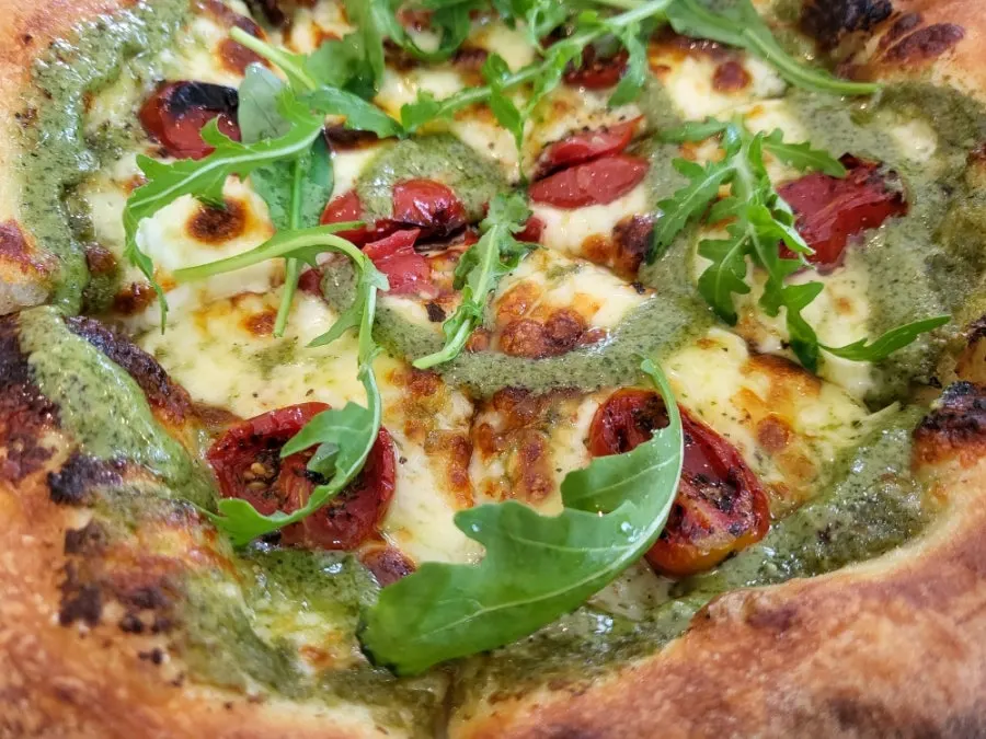 Pizza served with Tabasco hot sauce