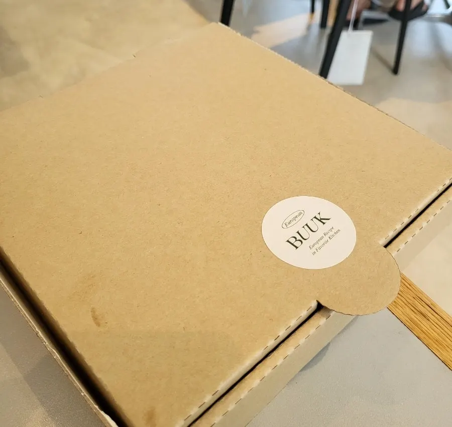A slice of margherita pizza being lifted up