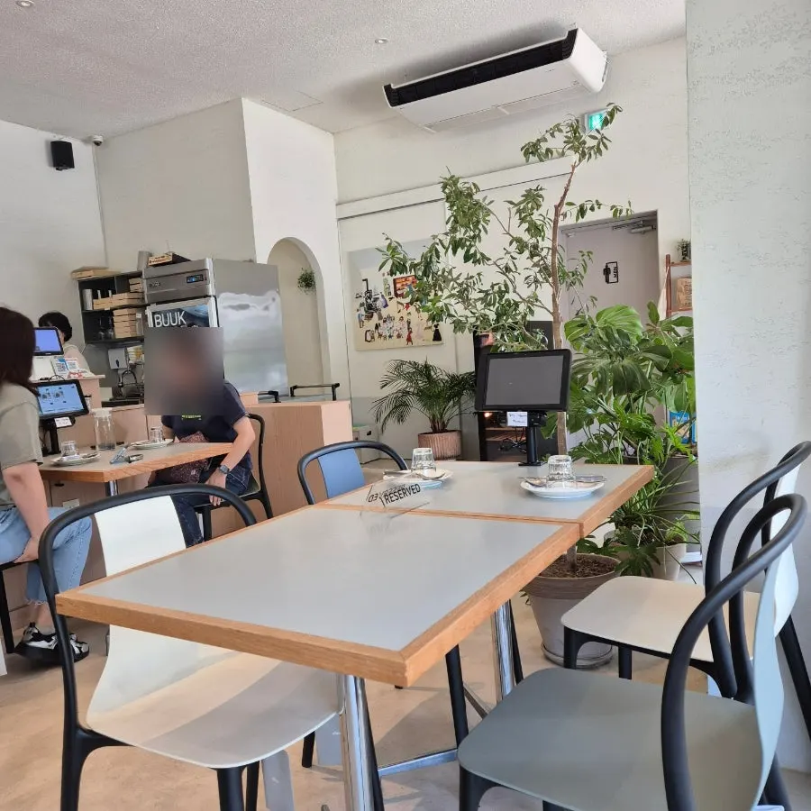 Indoor seating with trees visible through the picture window