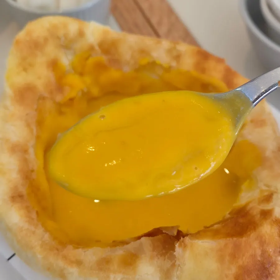 A piece of pastry soaked in soup