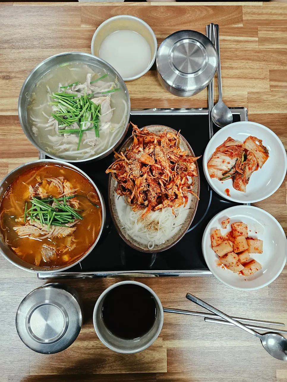 Table spread with dakgaejang, dakgomtang, and chicken muchim