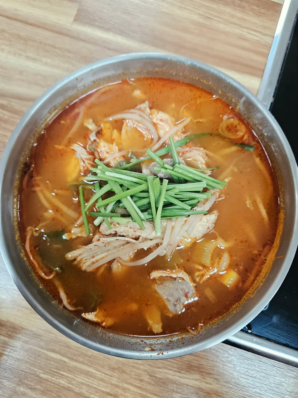 Stone bowl of dakgaejang with deep red broth