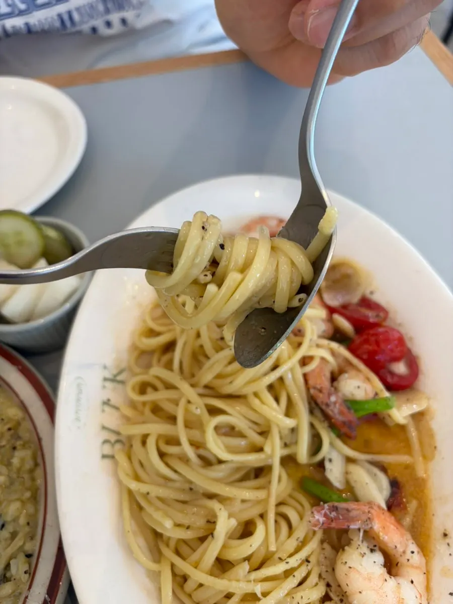 Close-up of oil pasta topped with shrimp