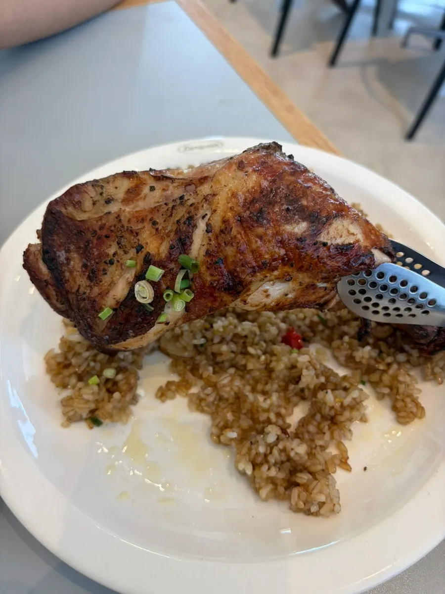 Kung Pao chicken pilaf topped with a whole chicken thigh