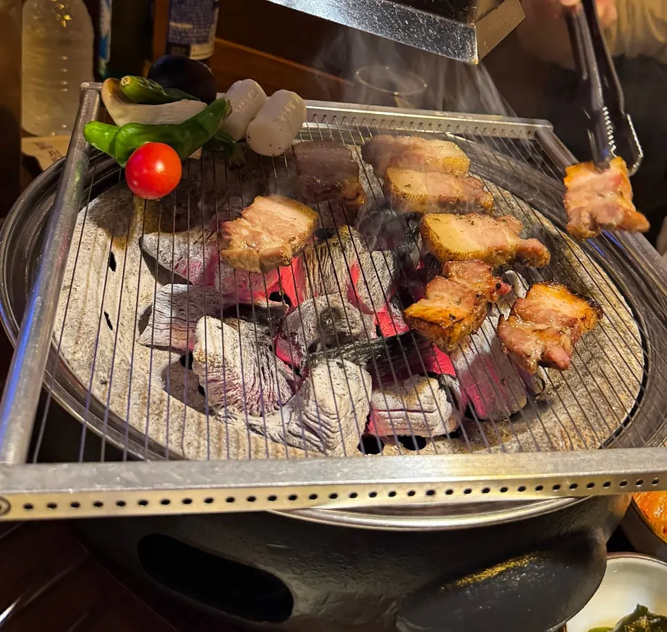 Smoked pork belly grilling to a golden brown