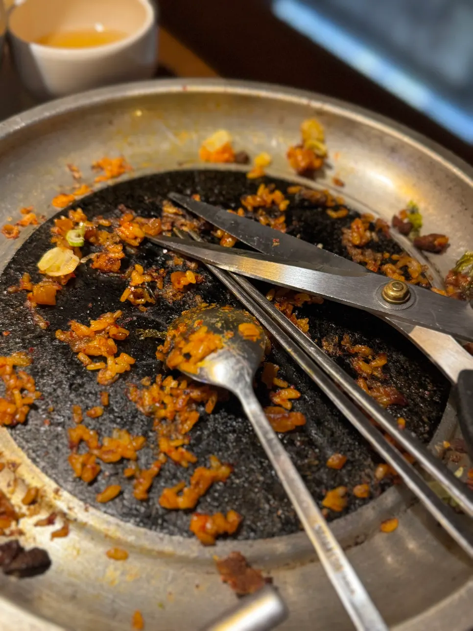 Crispy rice bits stuck to the bottom of the fried rice pan