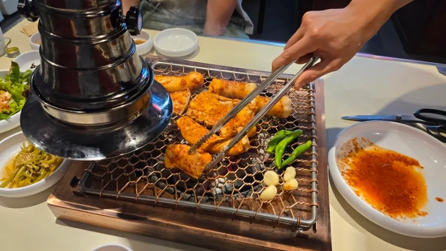 Staff member grilling on the tabletop grill