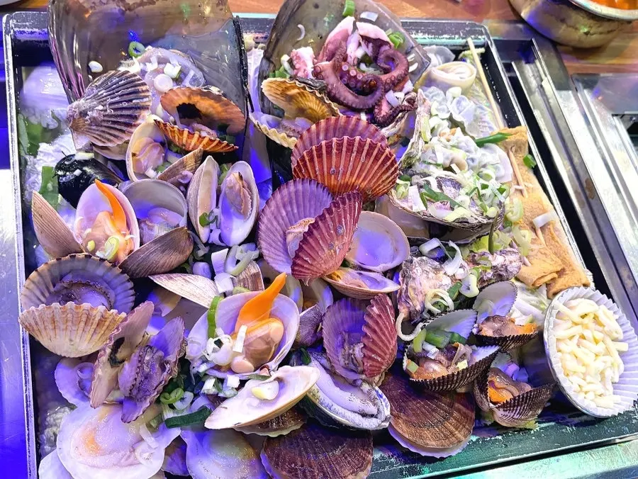 Dumplings and fish cake piled on the clam hot pot