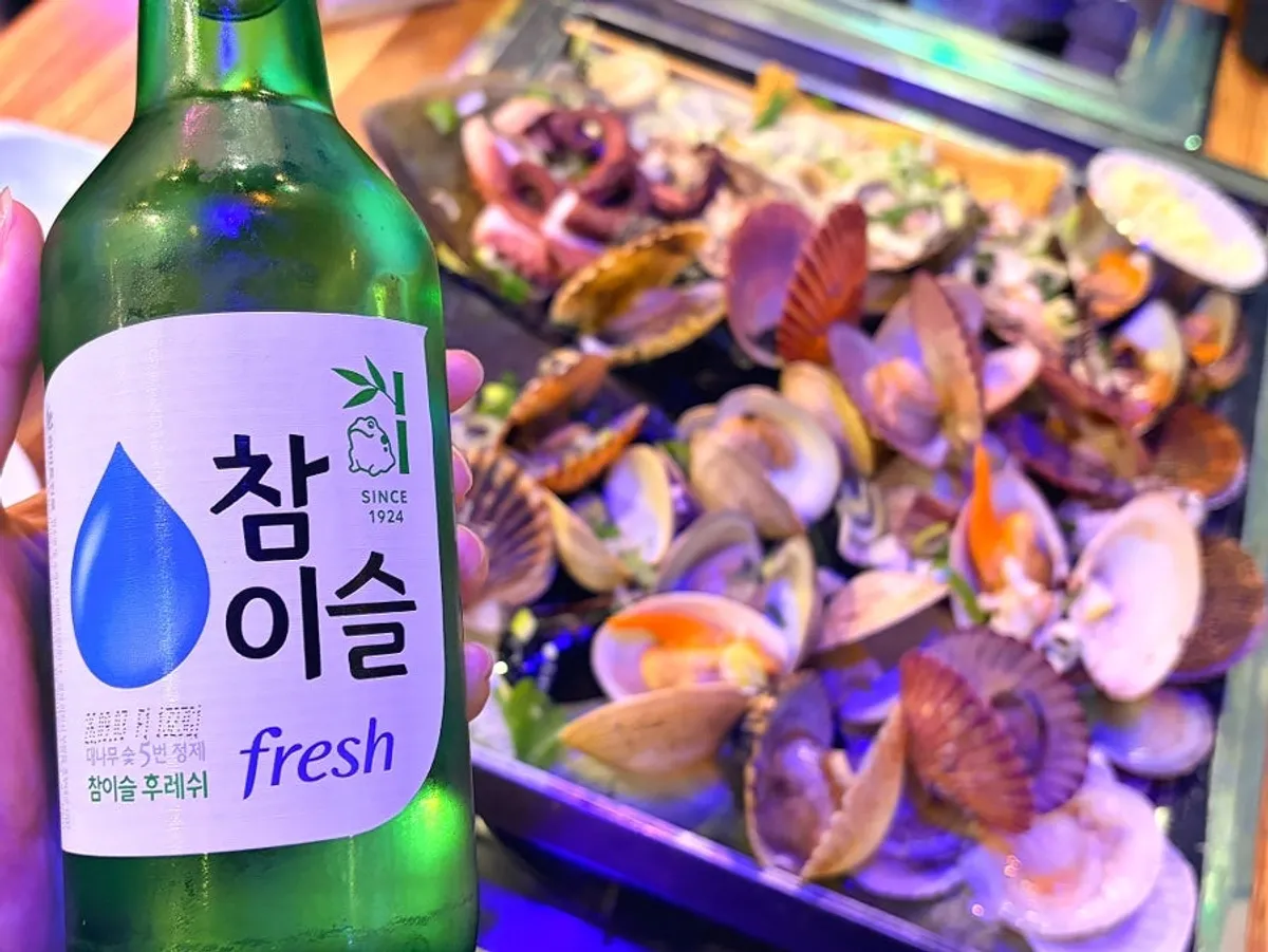 Clam hot pot with broth served alongside cheese topping