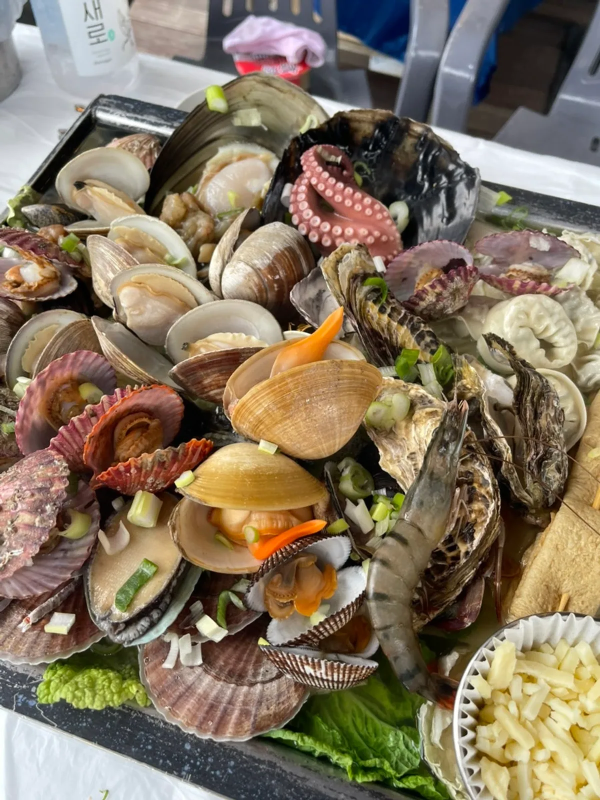 A bottle of cheongha alongside the clam steamer spread