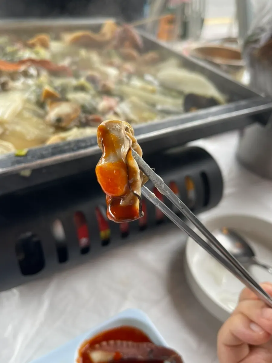 Eating clams topped with melted cheese