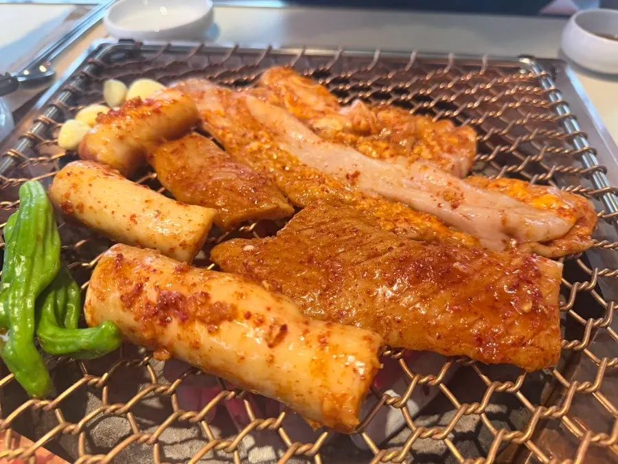 Staff grilling charcoal daechang tableside