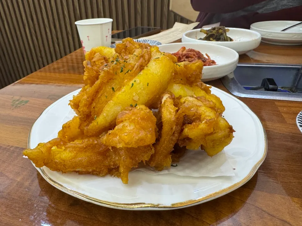 A pot filled with large octopus and clams