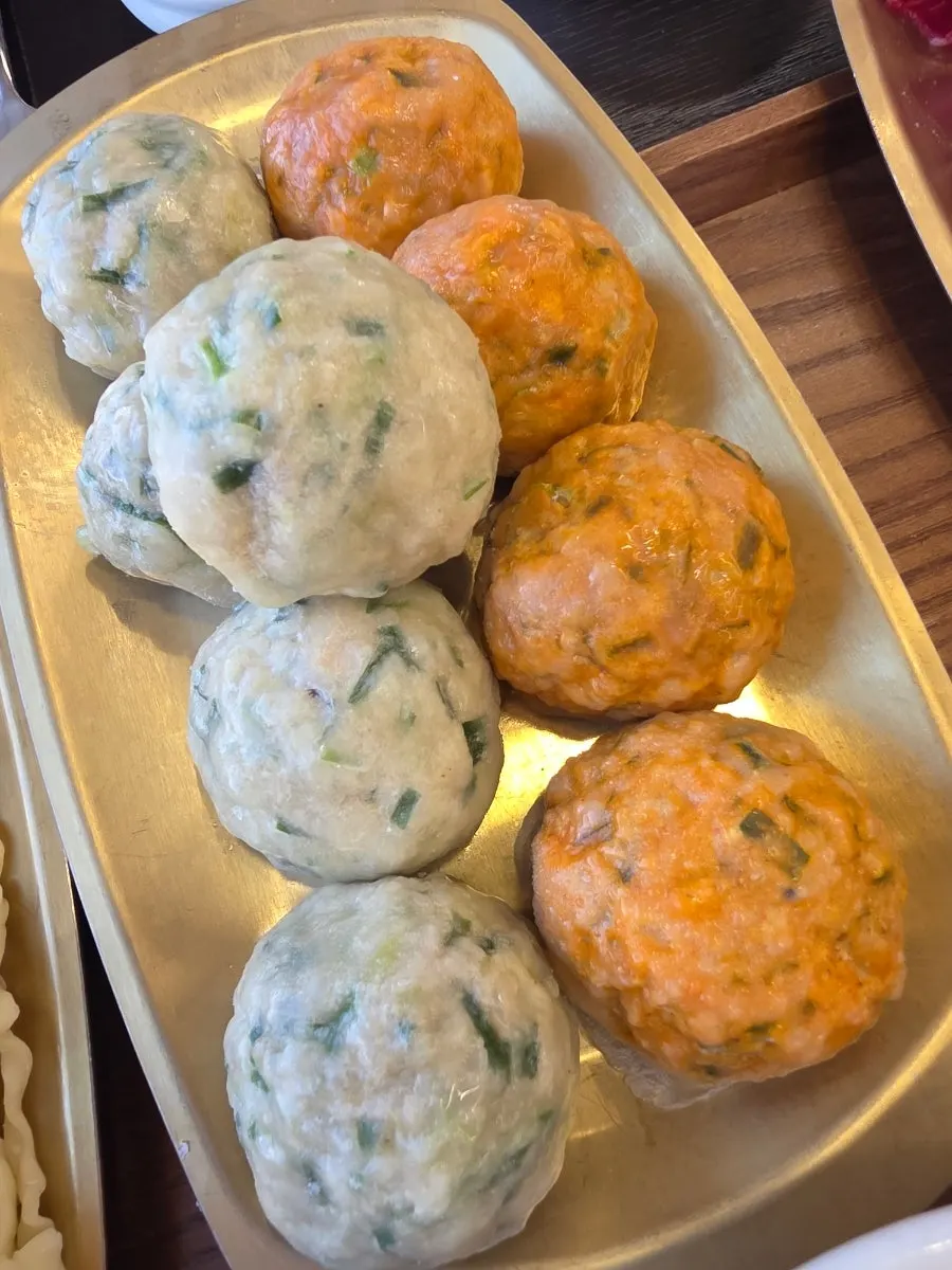 Hot pot with handmade rolled dumplings on top