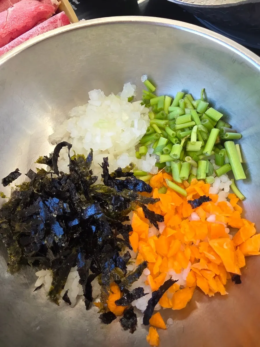 A plate of shabu beef and vegetables