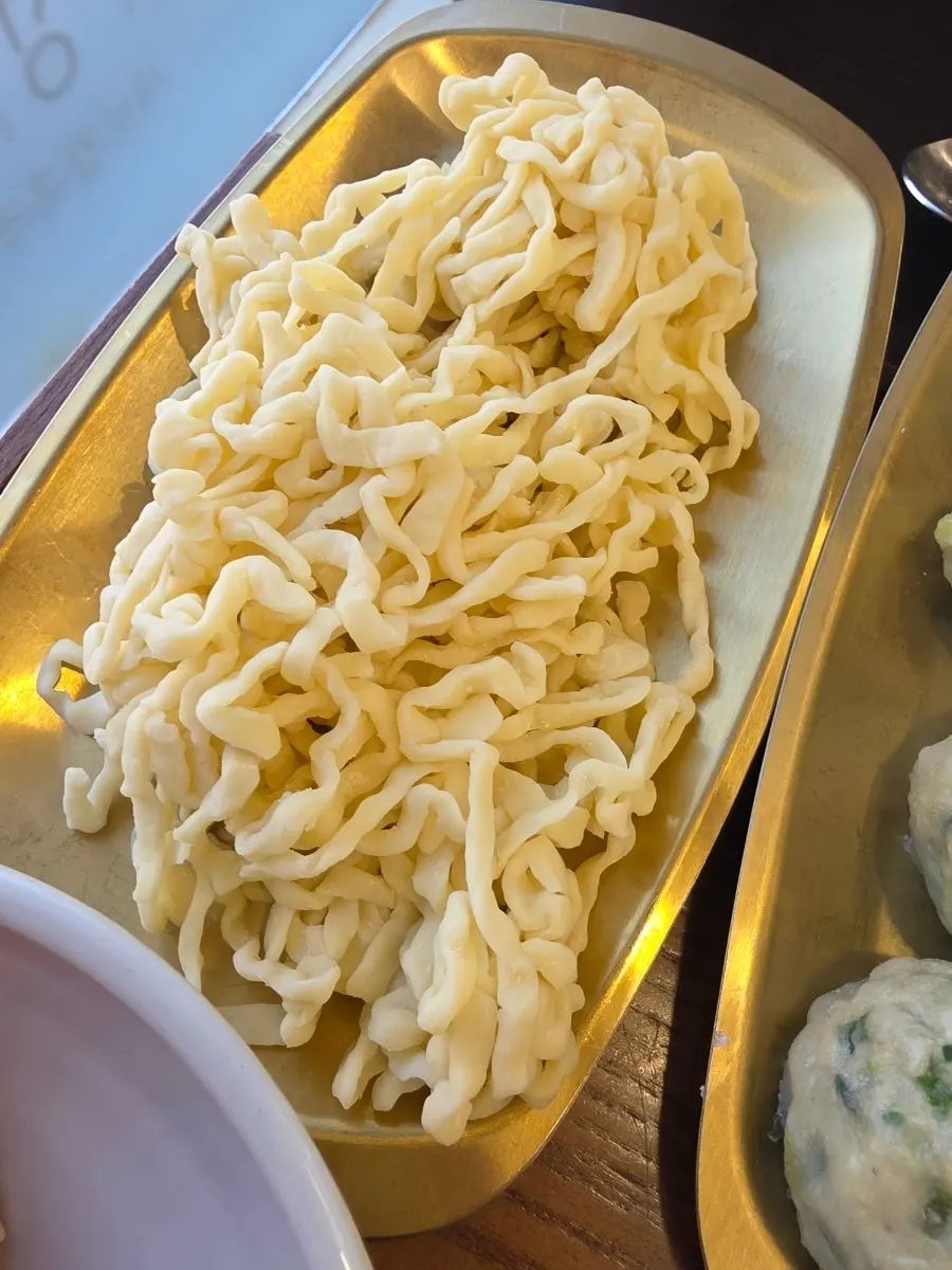 Kalguksu noodles cooked in the hot pot broth