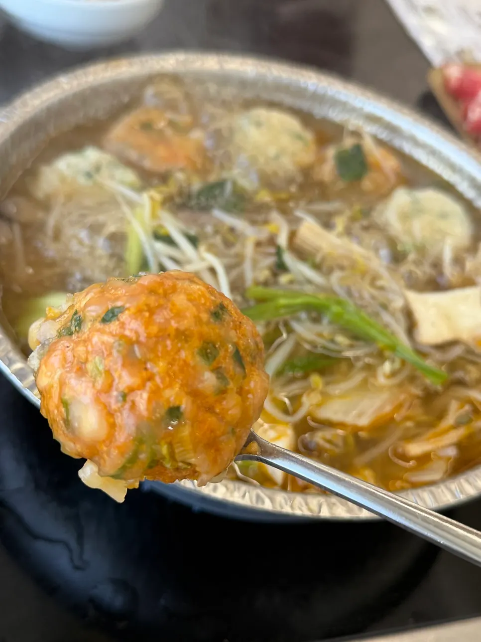Gulrim mandu cooking in the spicy broth
