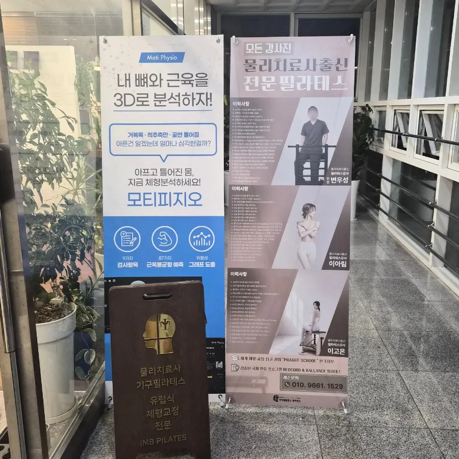 Studio entrance on the 2nd floor with a professional Pilates signboard