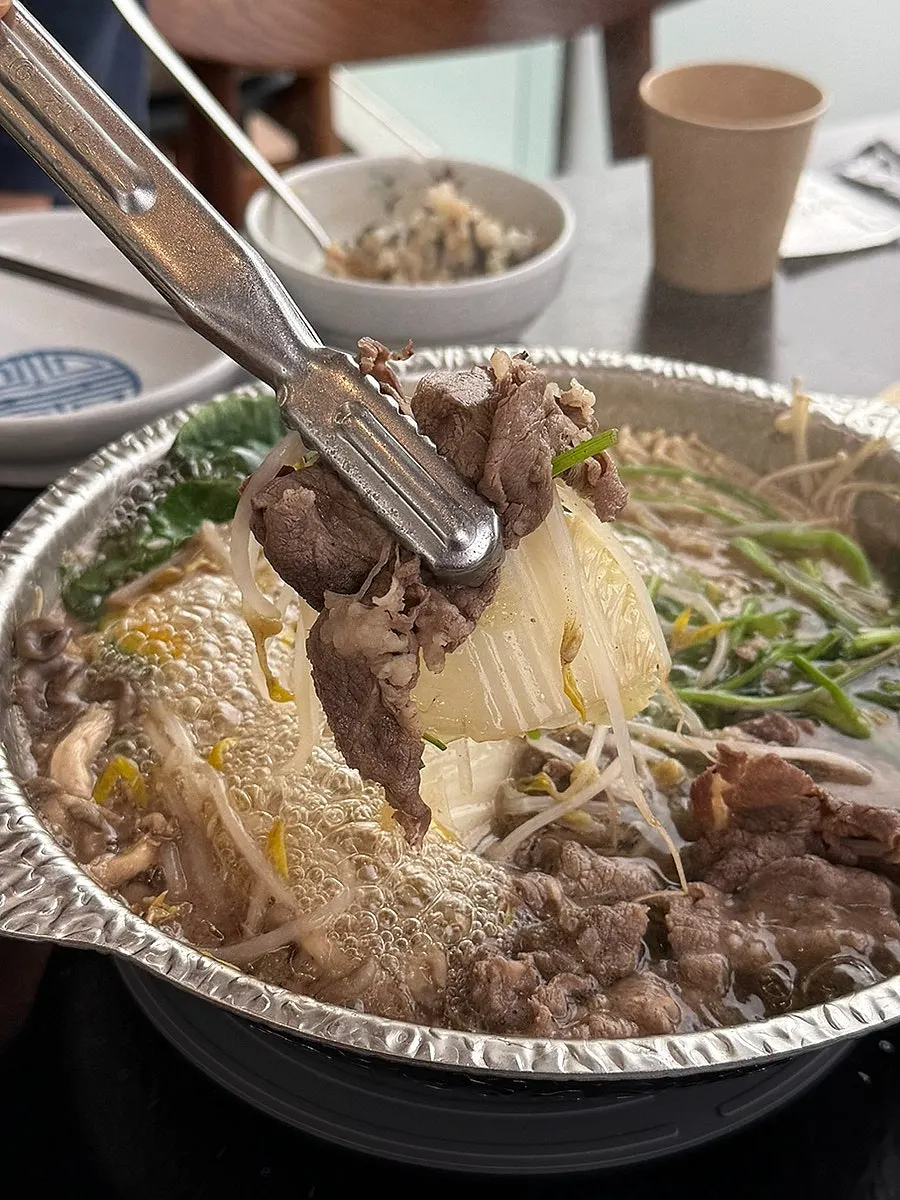 Shabu beef cooking in clear broth