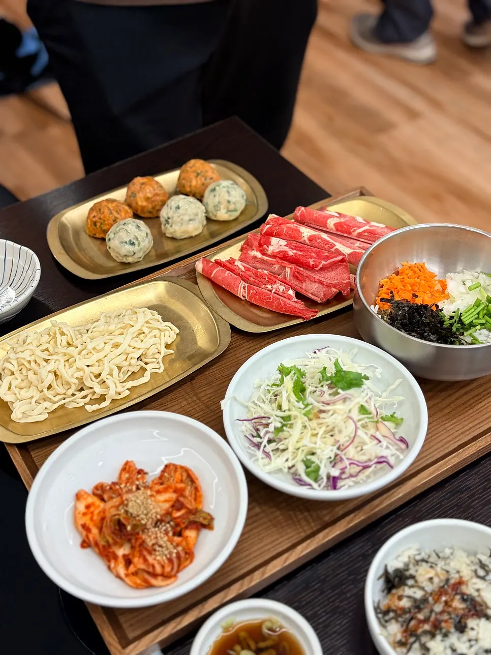 Menu listing prices for shabu kalguksu and mandu hot pot