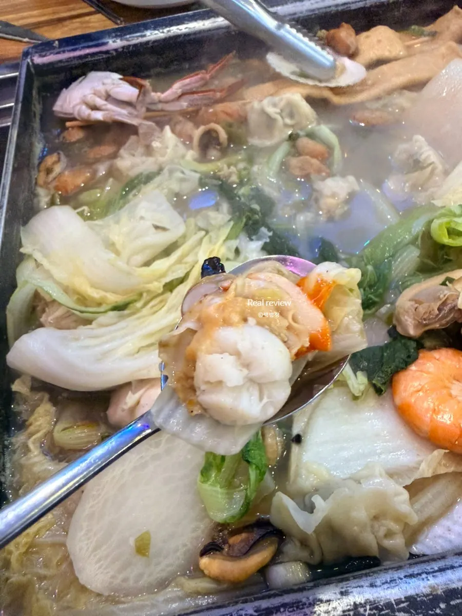 굴과 조개를 집어 든 모습
