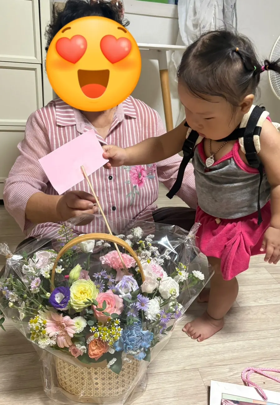 Grandmother smiling after receiving the flower basket gift