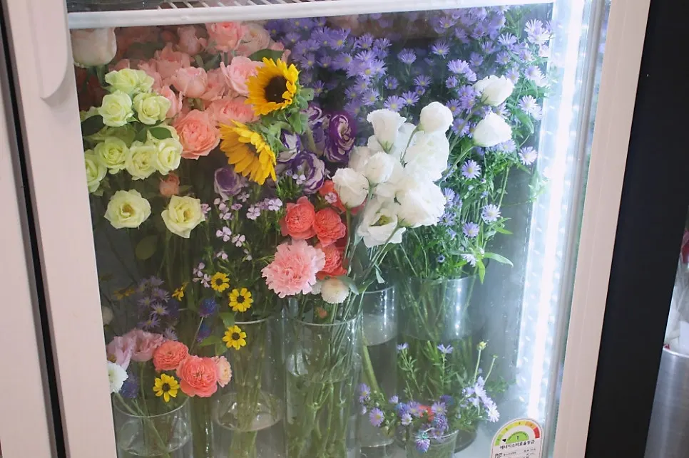 Colorful buckets of fresh flowers on display
